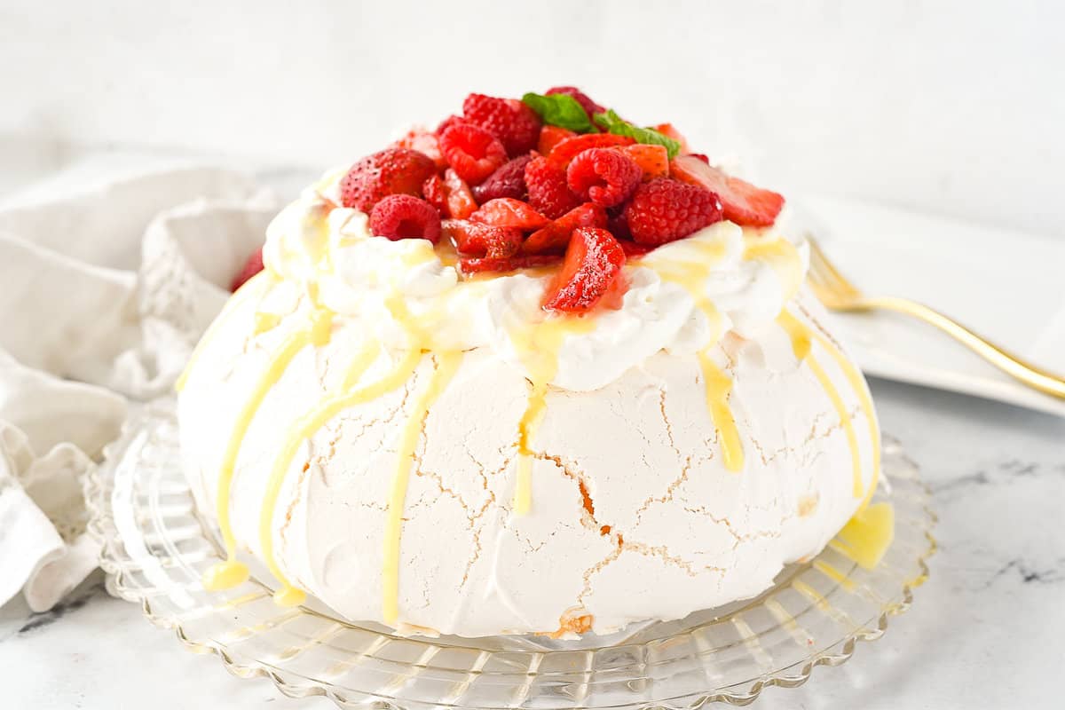 PAVLOVA ONA PLATE WITH BERRIES ON TOP