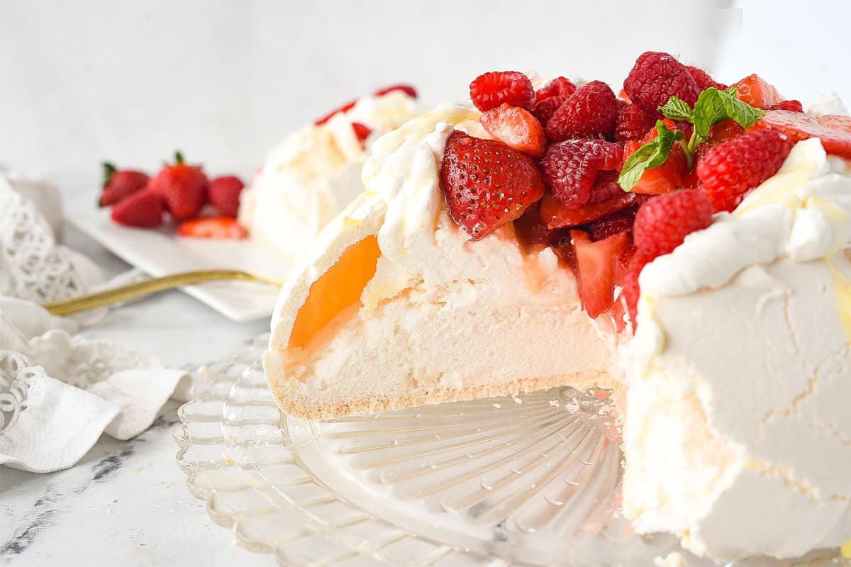 pavlova dessert with a slice missing