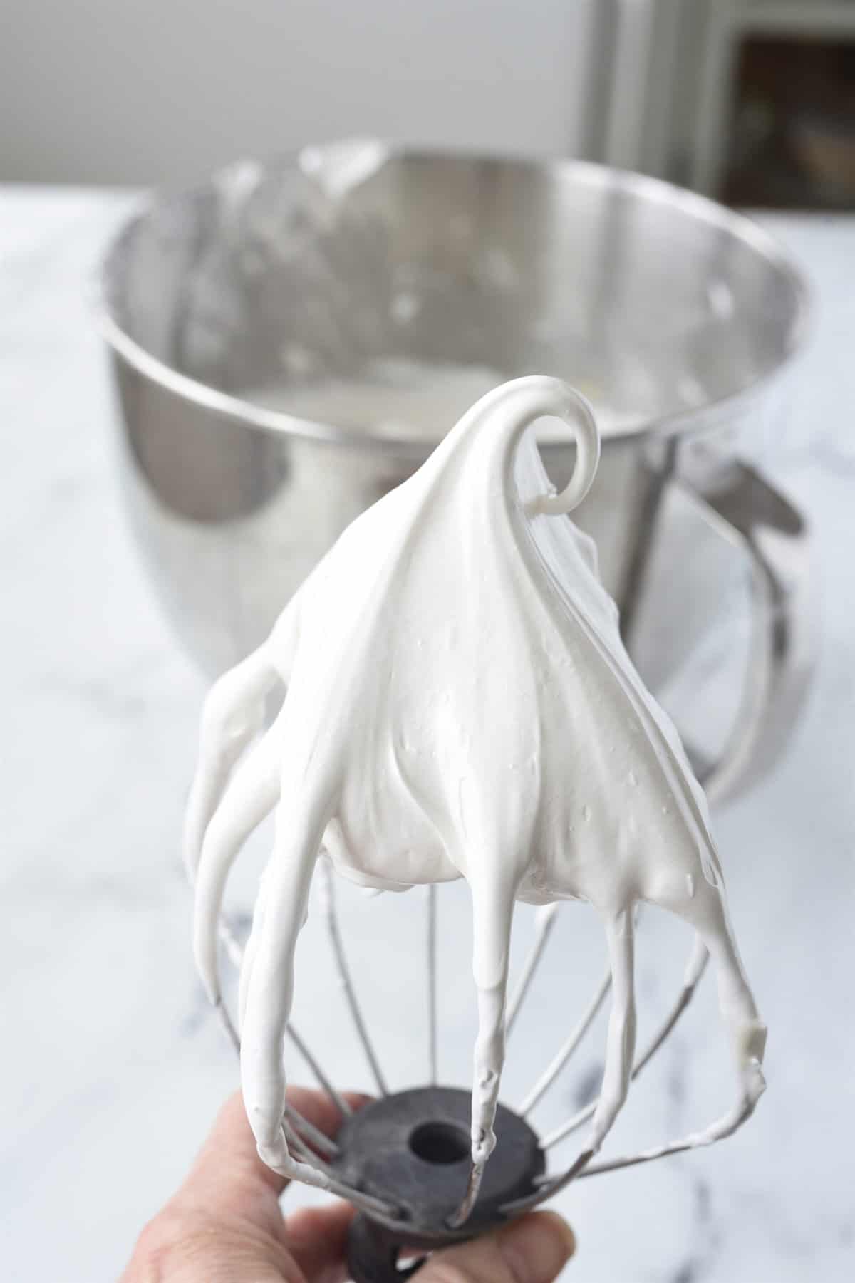 thick and glossy meringue on whisk