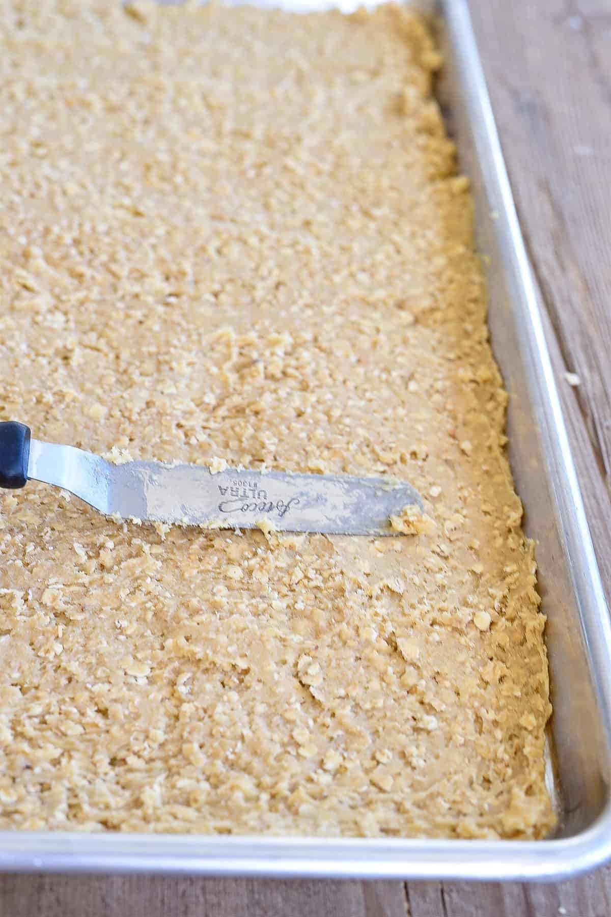 spreading dough in a pan