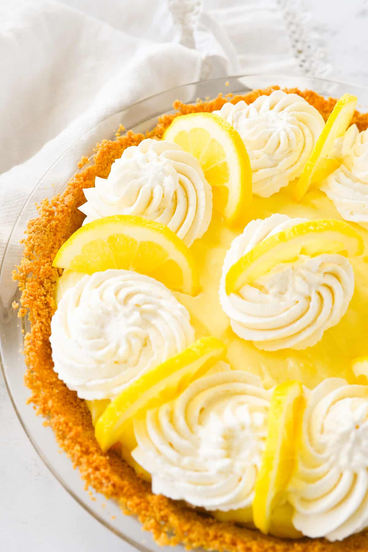 sour cream lemon pie with pipped whipped cream on top