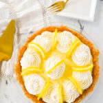 overhead shot of a sour cream lemon pie and a plate and fork