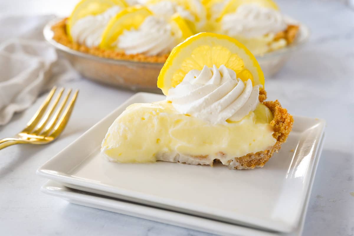 slice of sour cream lemon pie on a white plate