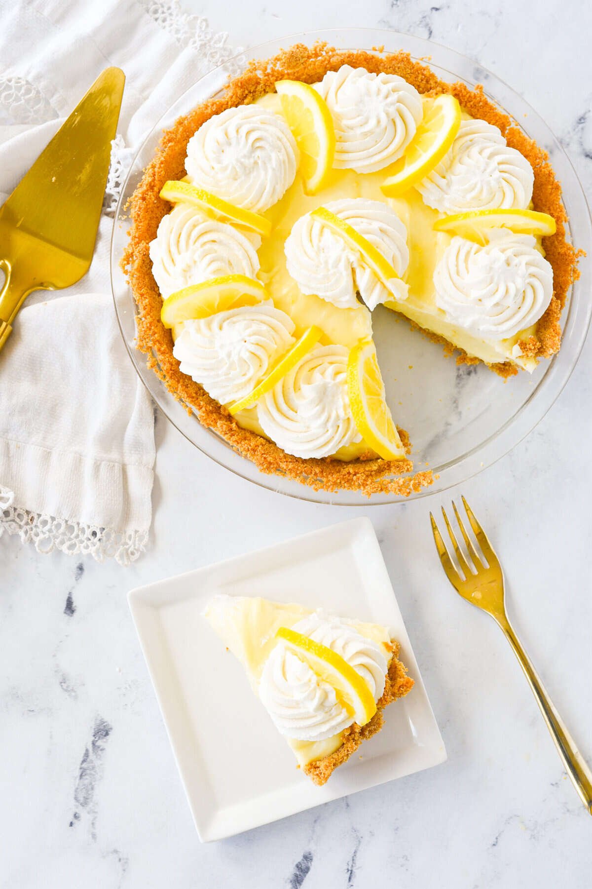 sour  cream lemon pie with a slice on a white plate