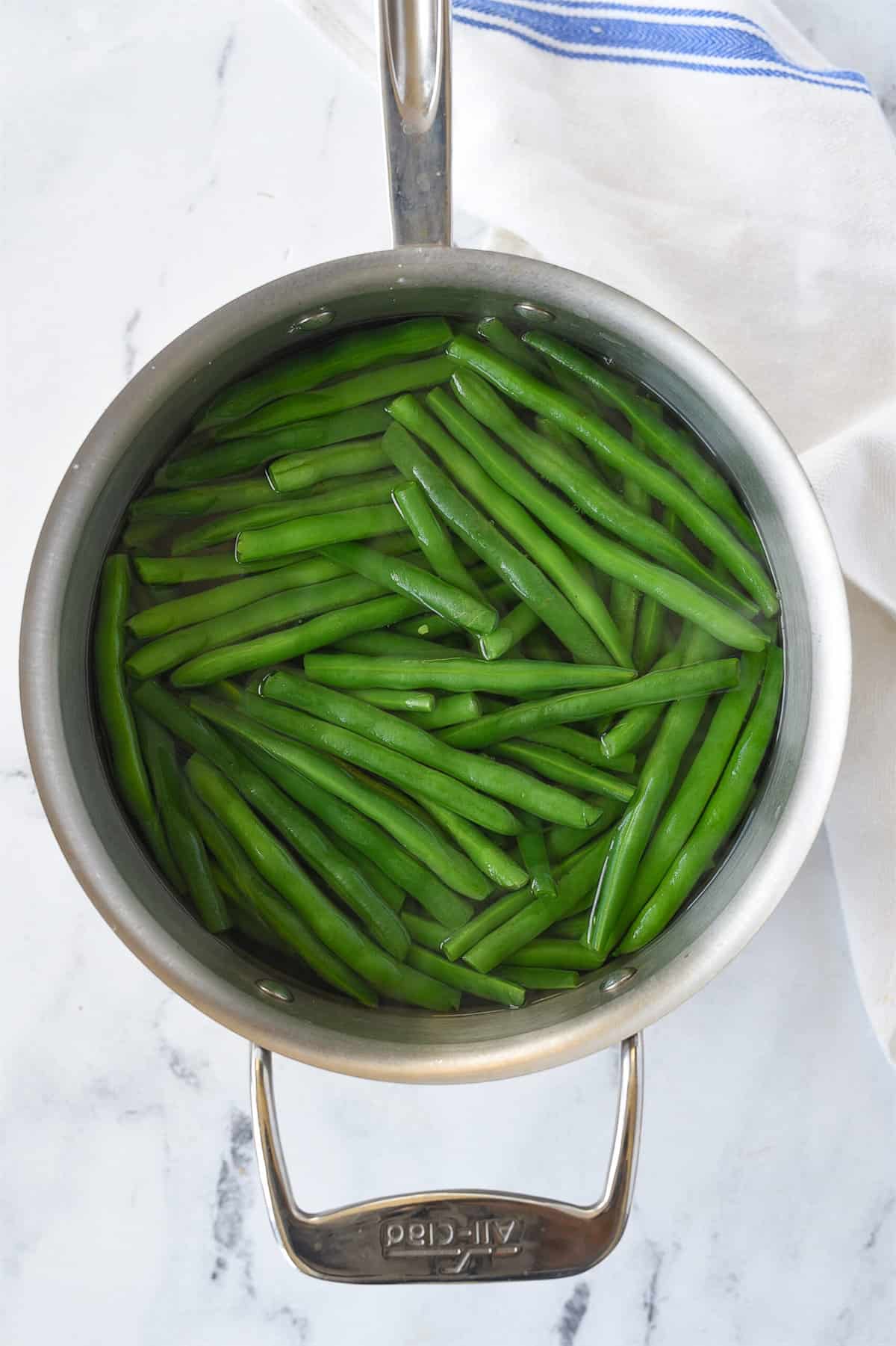 blanching green beans in a pan