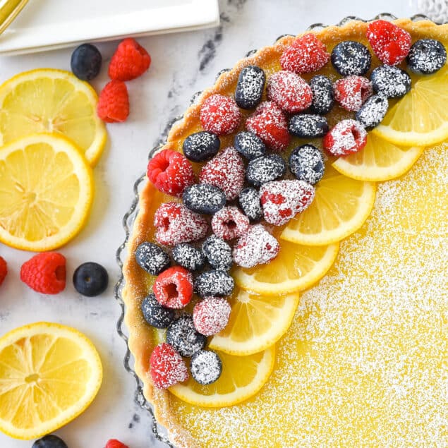 overhead shot of a lemon tart topped with fruit