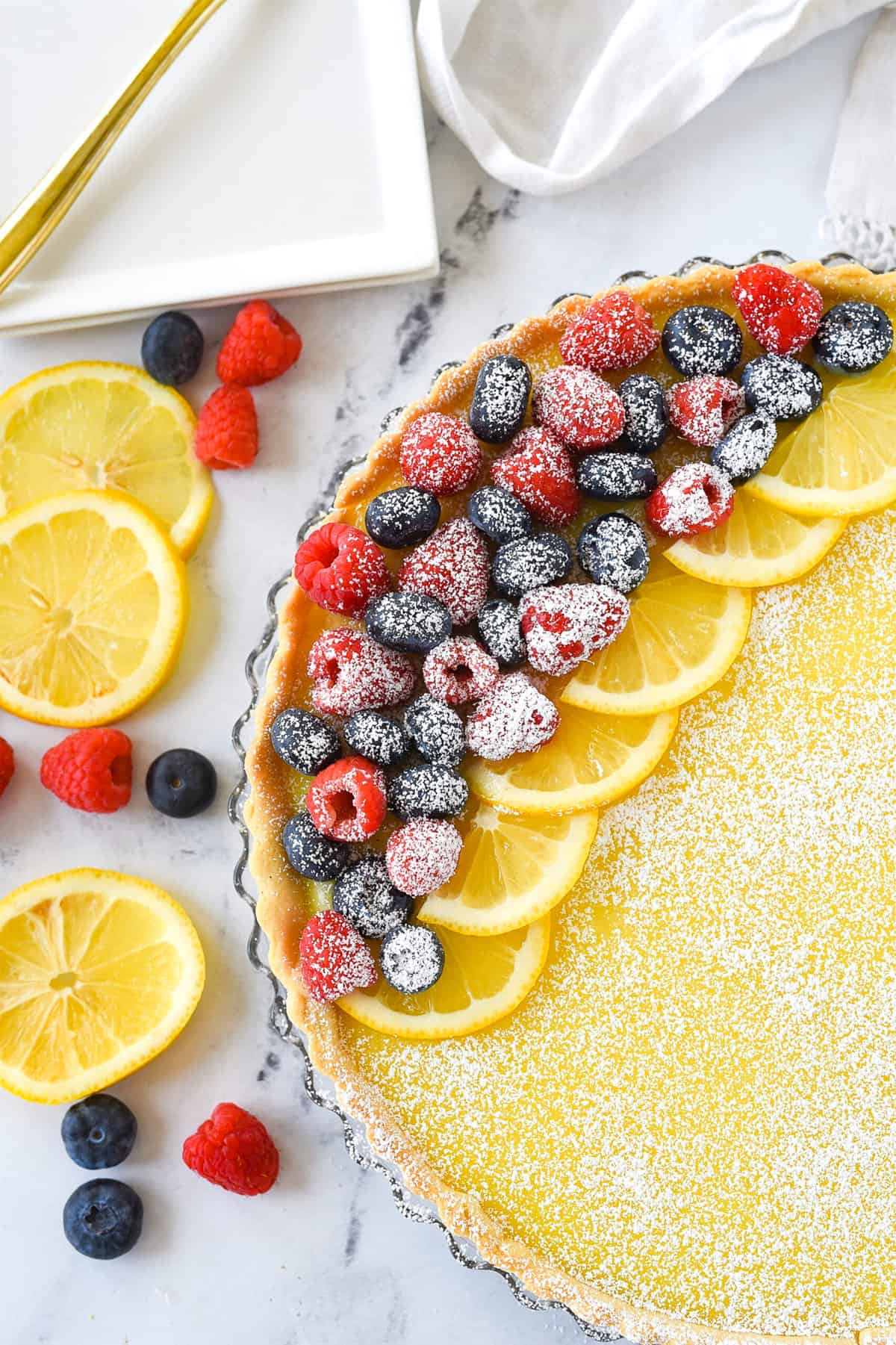 overhead shot of a lemon tart topped with fruit