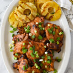 huli huli chicken and pineapple on a white platter