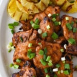 grilled huli huli chicken on a plate with pineapple