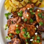grilled huli huli chicken on a plate with pineapple