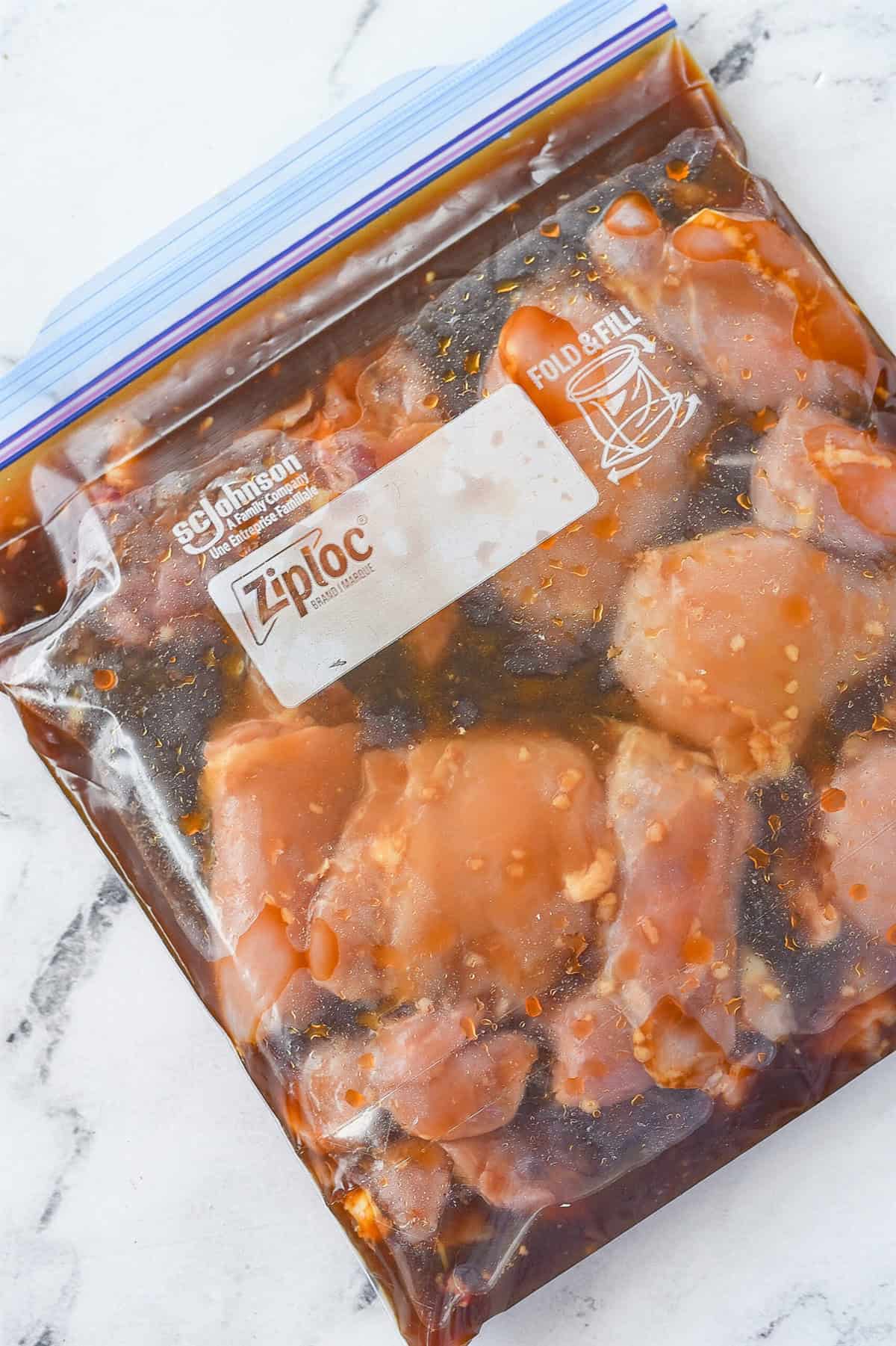 chicken marinading in a plastic bag