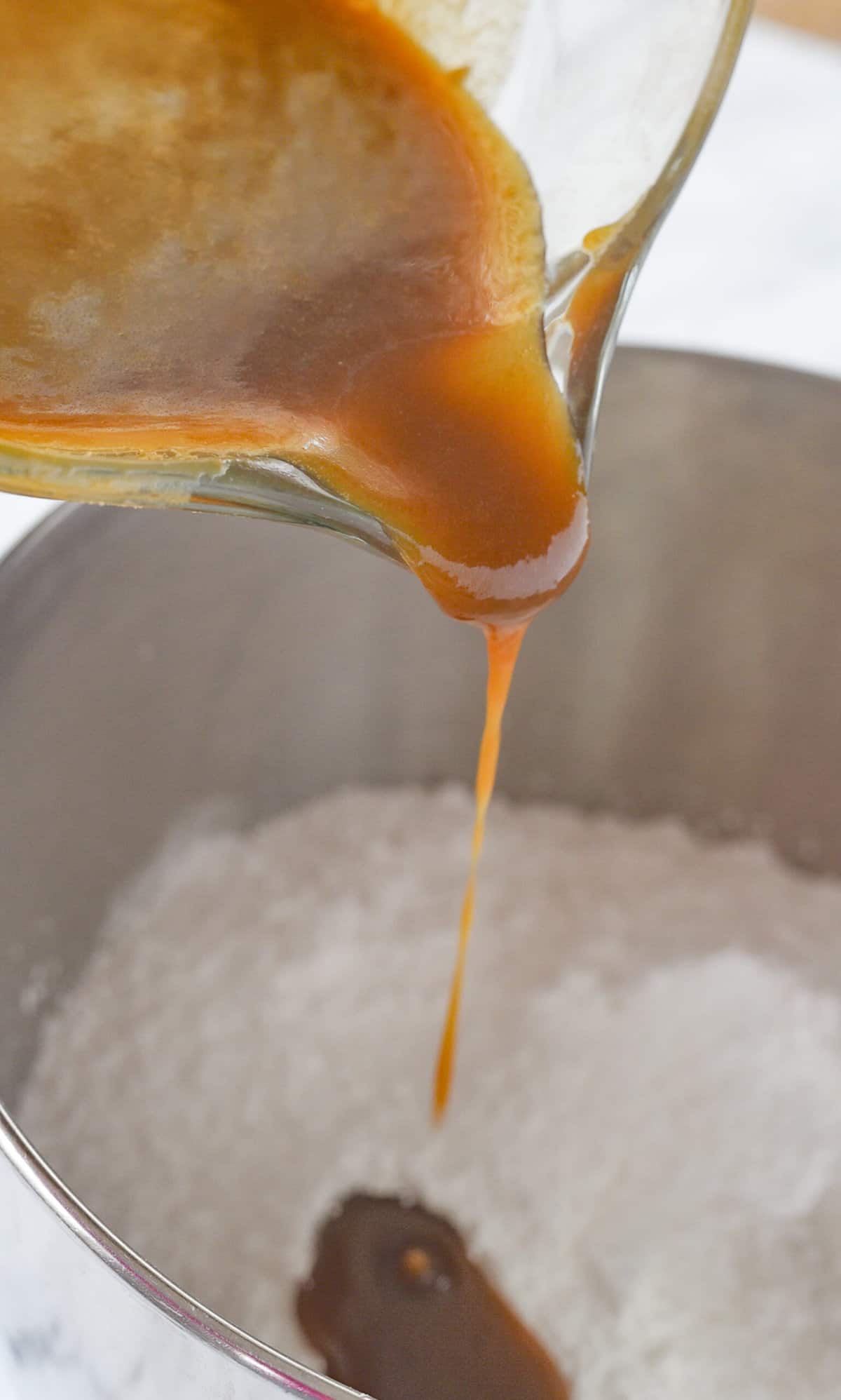 pouring caramel sauce into powdered sugar