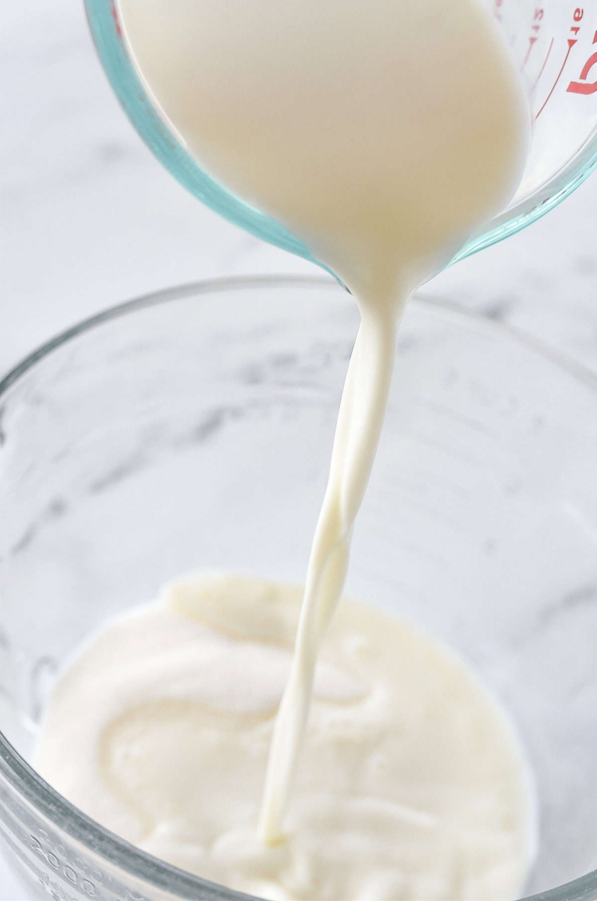 POURING MILK KINTO A MEASURING CUP]
