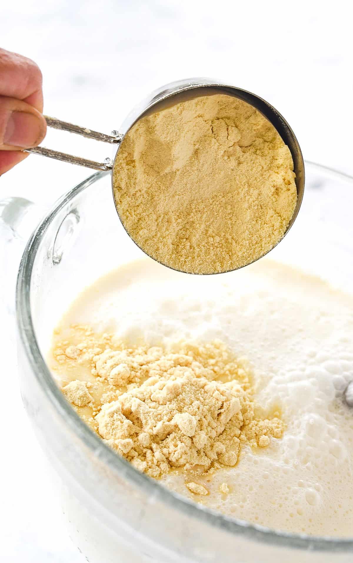adding malted milk powder to ice cream mixture
