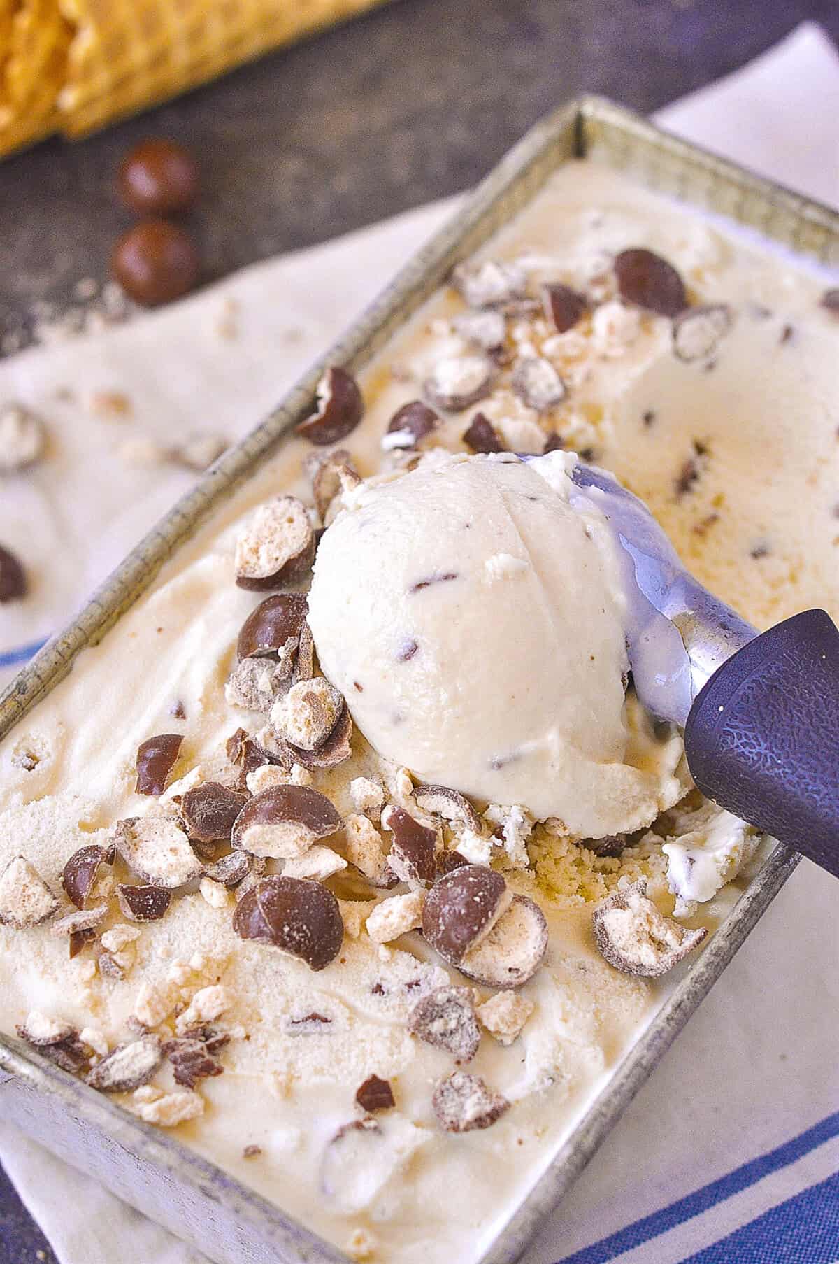 an ice cream scoop, scooping up ice cream