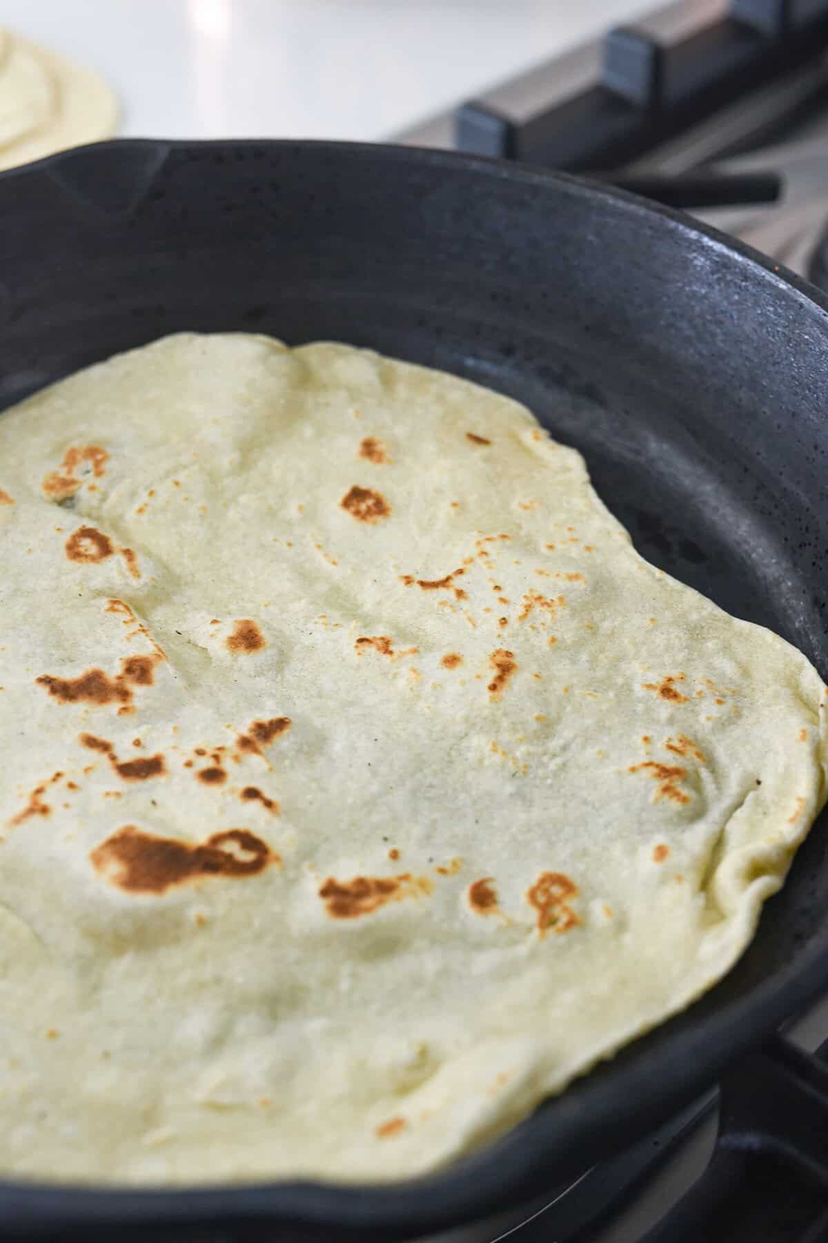 cooked tortilla in a cast iron pan