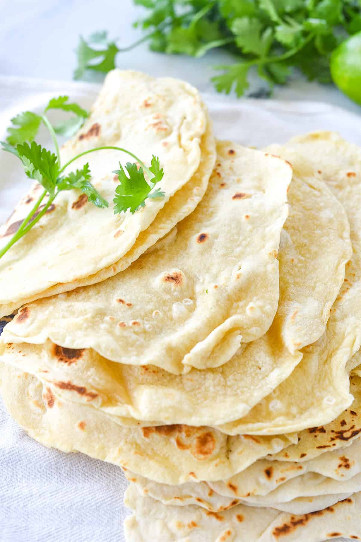 flour tortillas in a pile on a towel