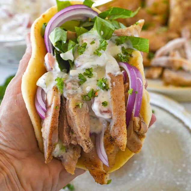 hand holding a chicken shawarma wrap