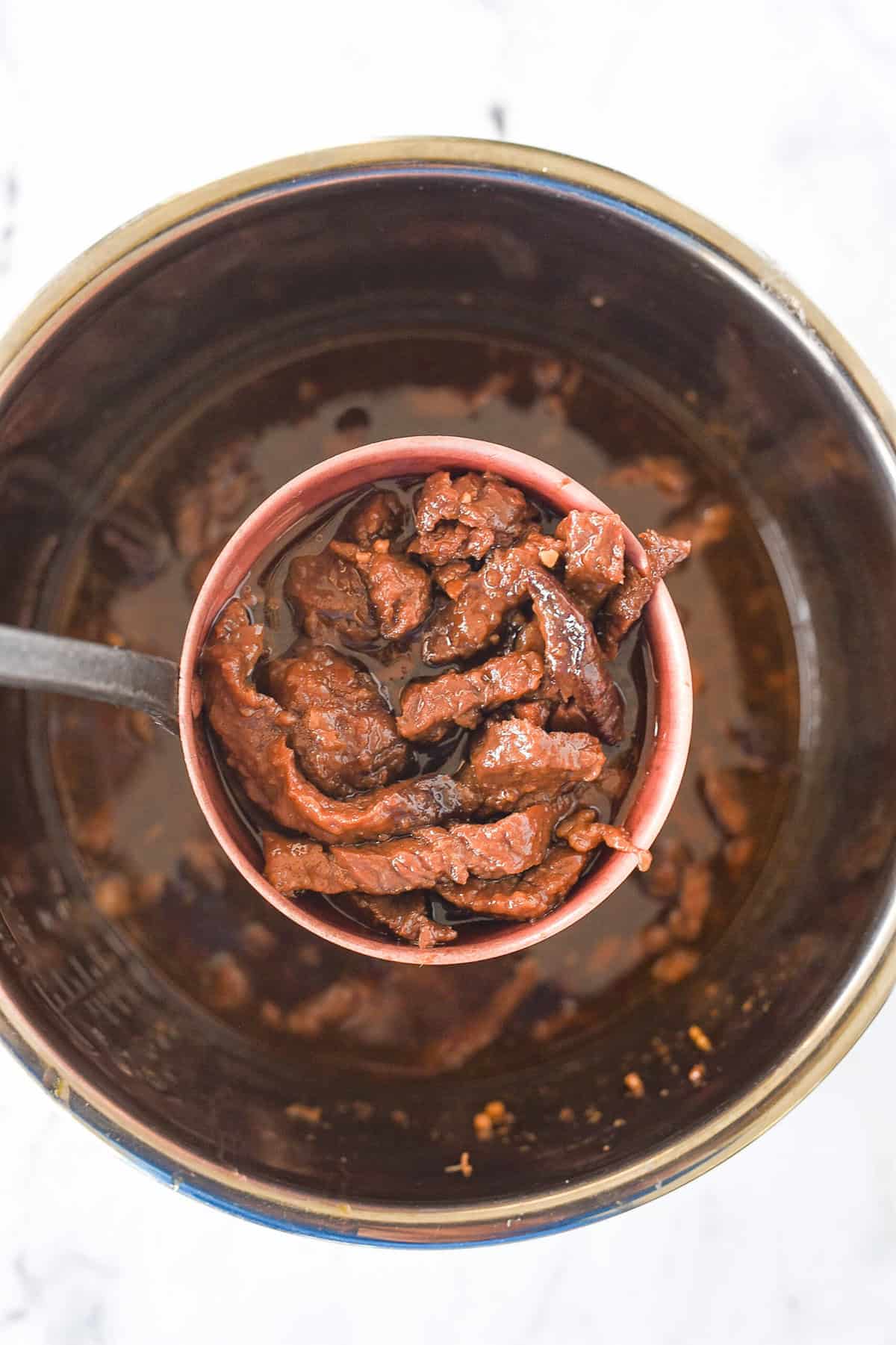ladle full of mongolian beef