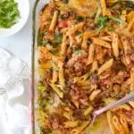 baked ziti in a pan with a spoon in it