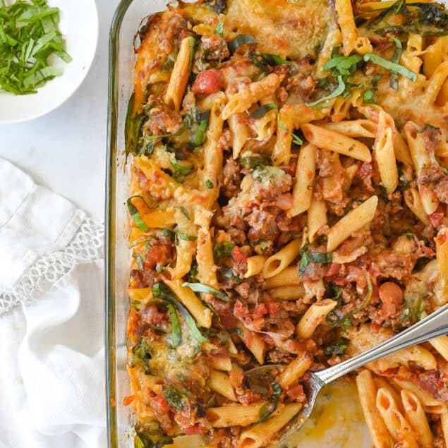 baked ziti in a pan with a spoon in it