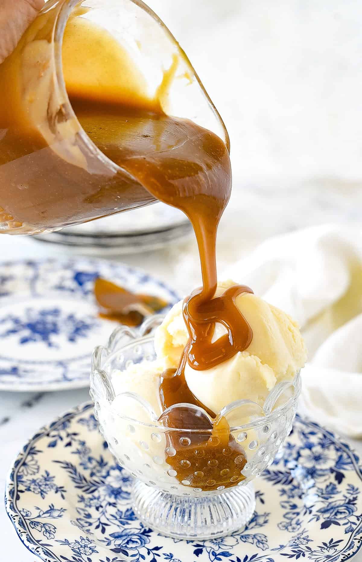 pouring caramel sauce on ice cream
