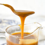 spoon drizzling caramel sauce into a bowl