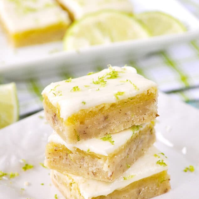 stack of key lime bars on a white plate