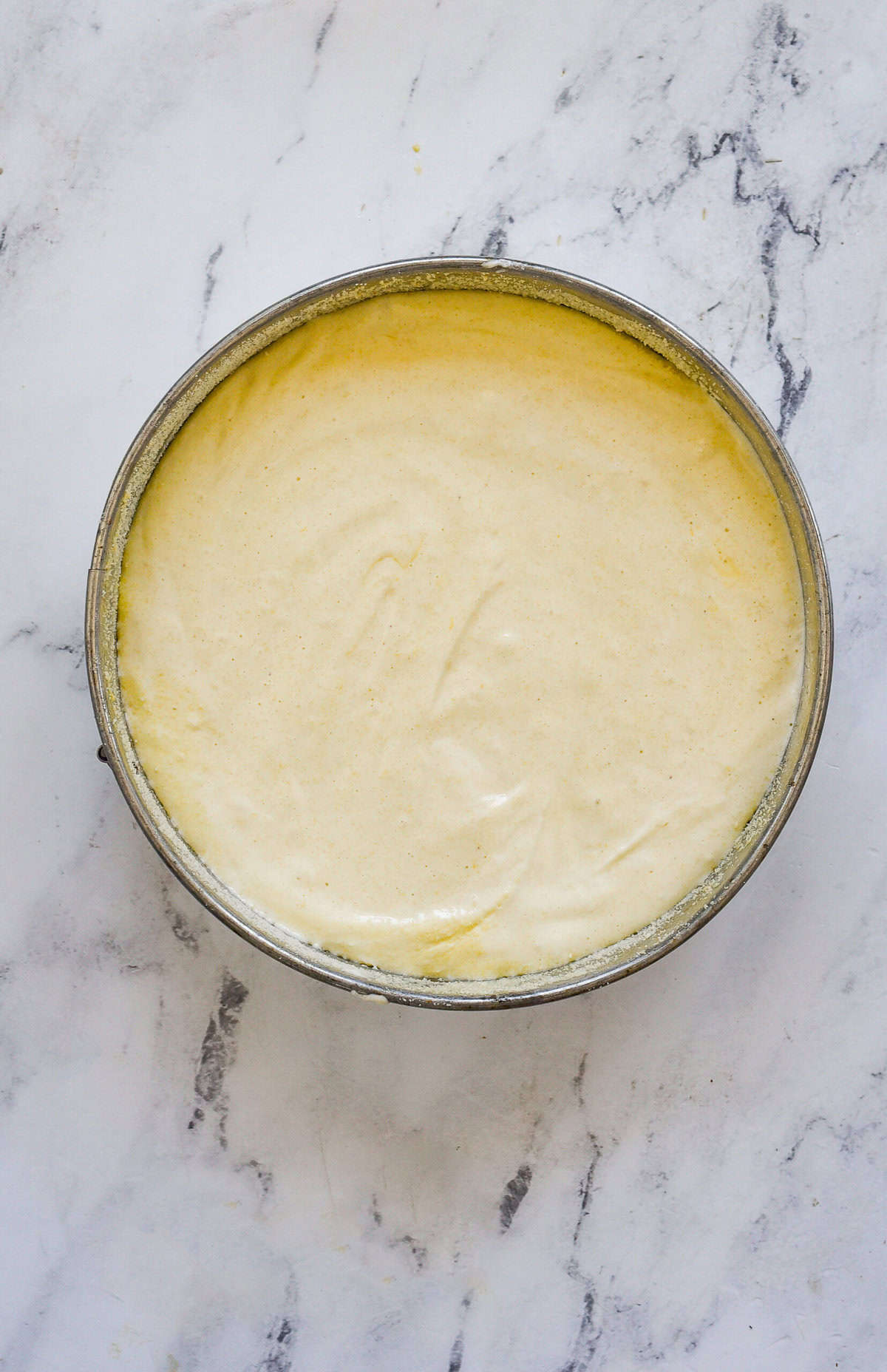 almond cake batter in springform pan
