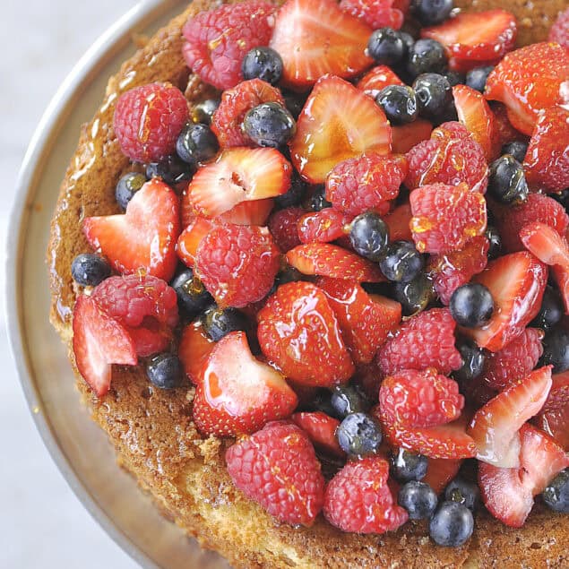 overehead shot of almond cake with berries on top