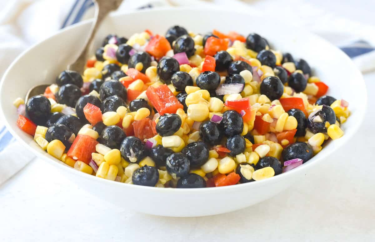 white bowl full of blueberry corn salad