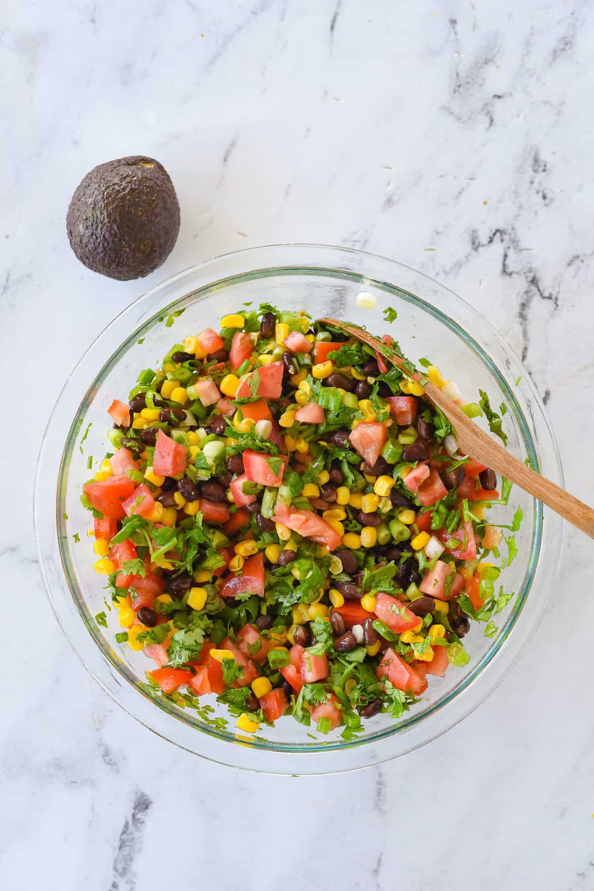 overhead shot of cowboy caviar with an avocado by the bowl