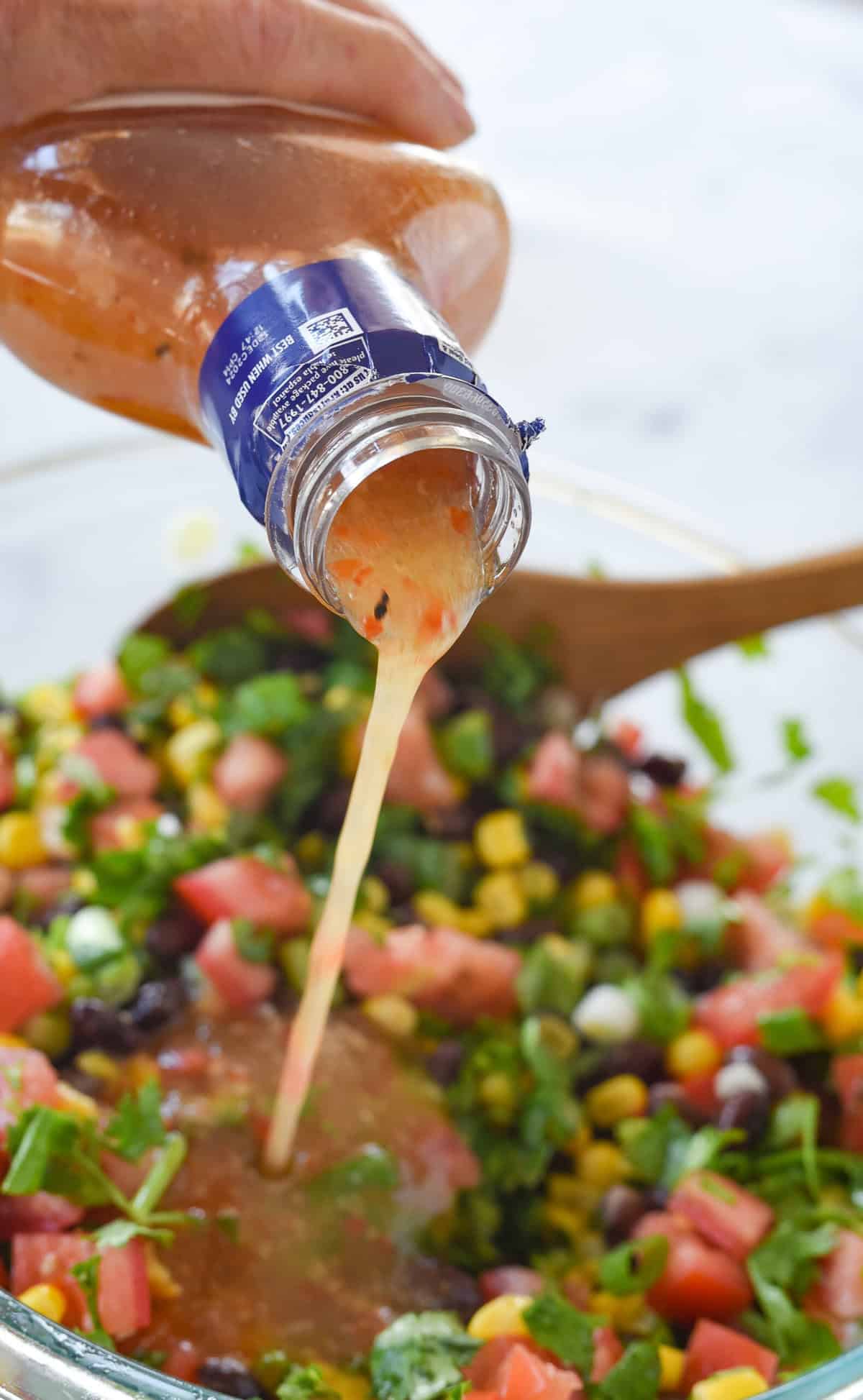 adding salad dressing to cowboy caviar
