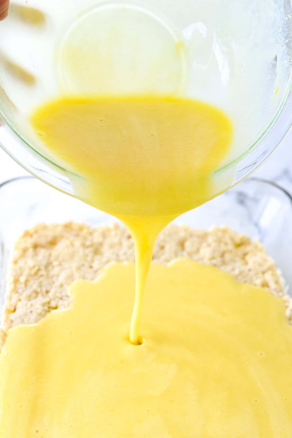 pouring key lime mixture over crust