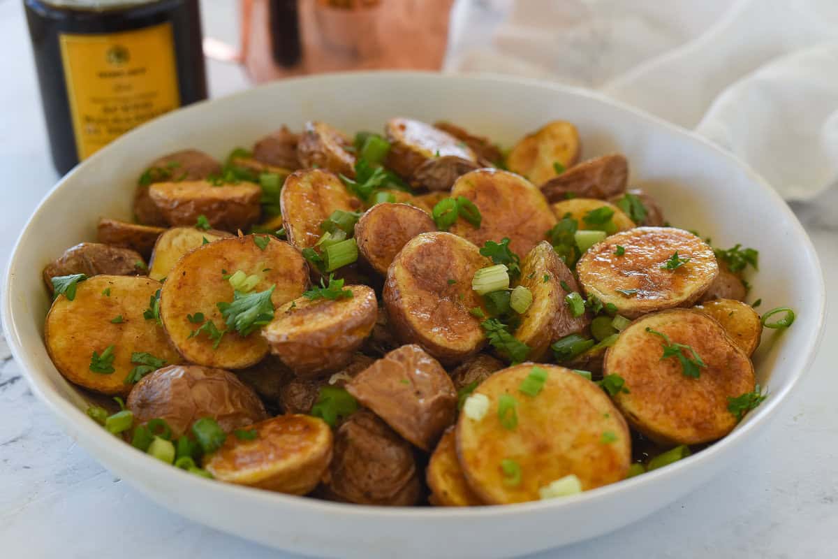 white bowl with balsamic roasted potatoes in it
