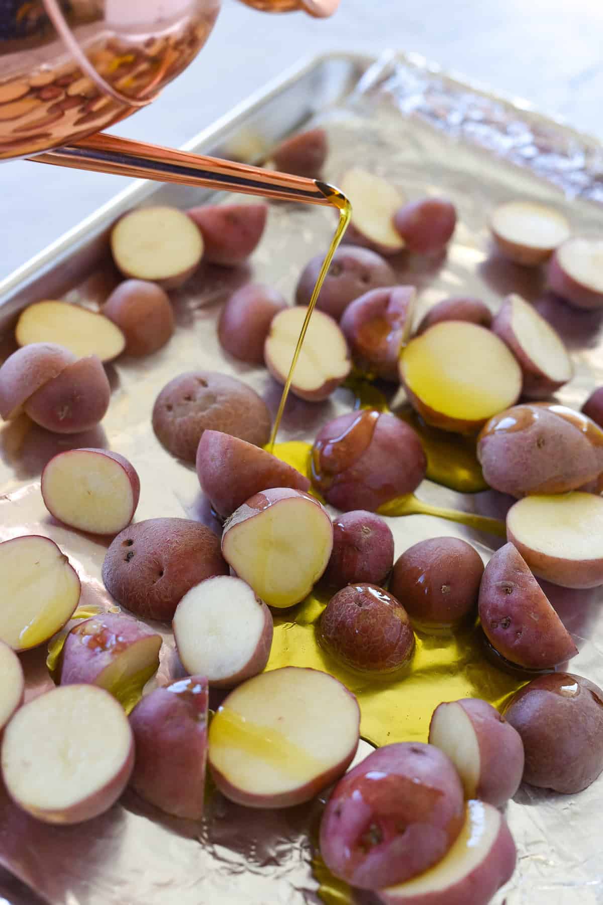 drizzling red potatoes with olive oil