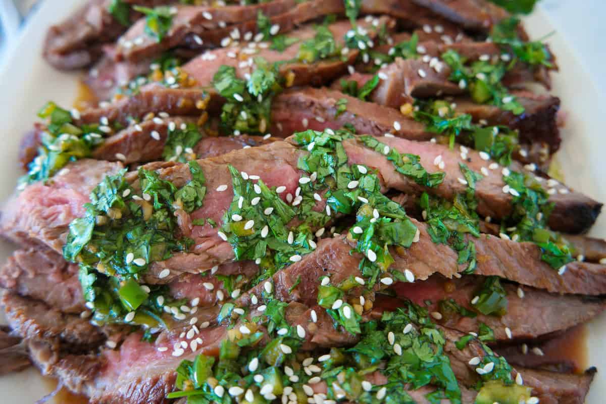 closeup of flank steak with chimchurri on top