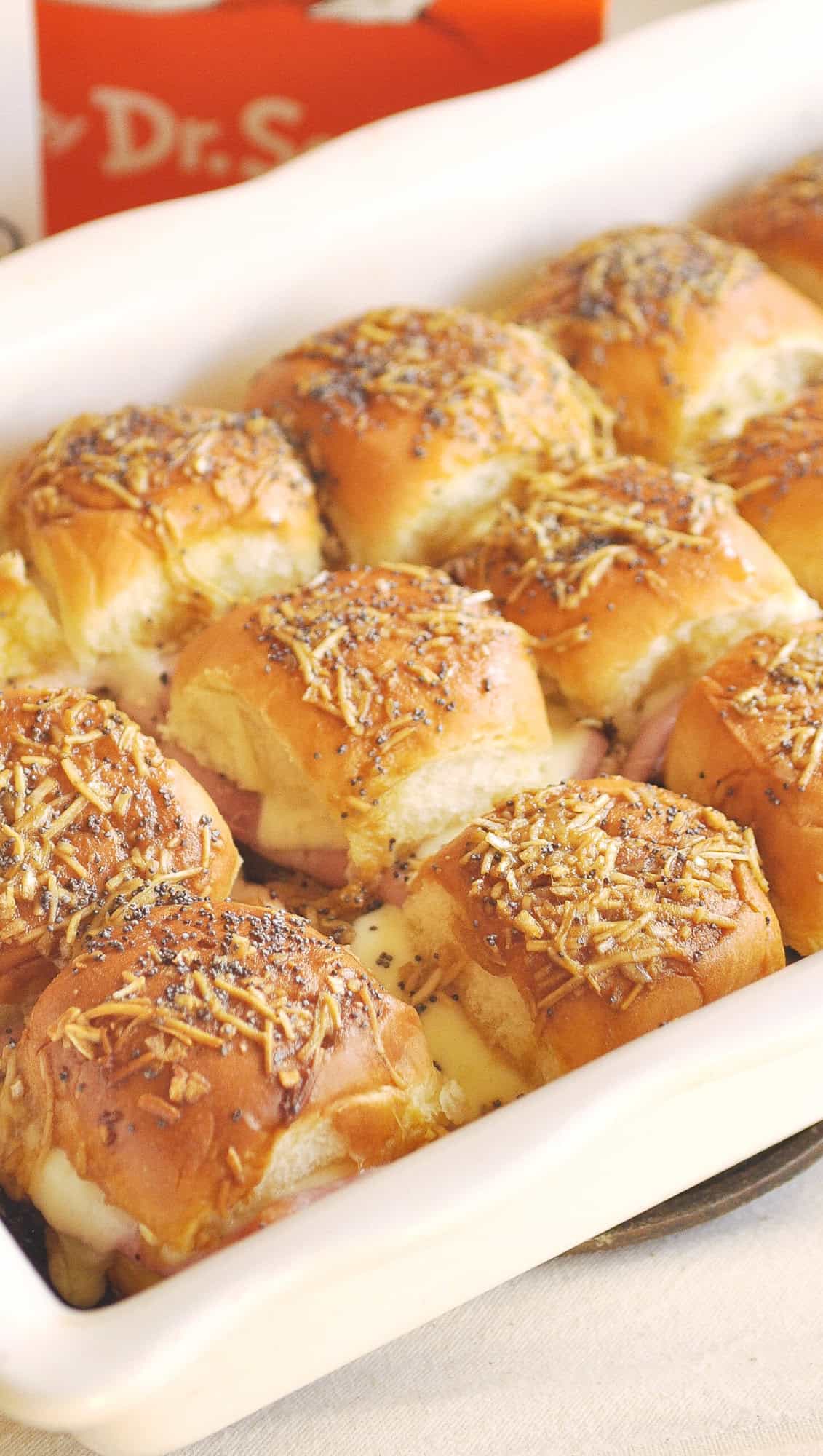 ham and cheese sliders in a white baking dish