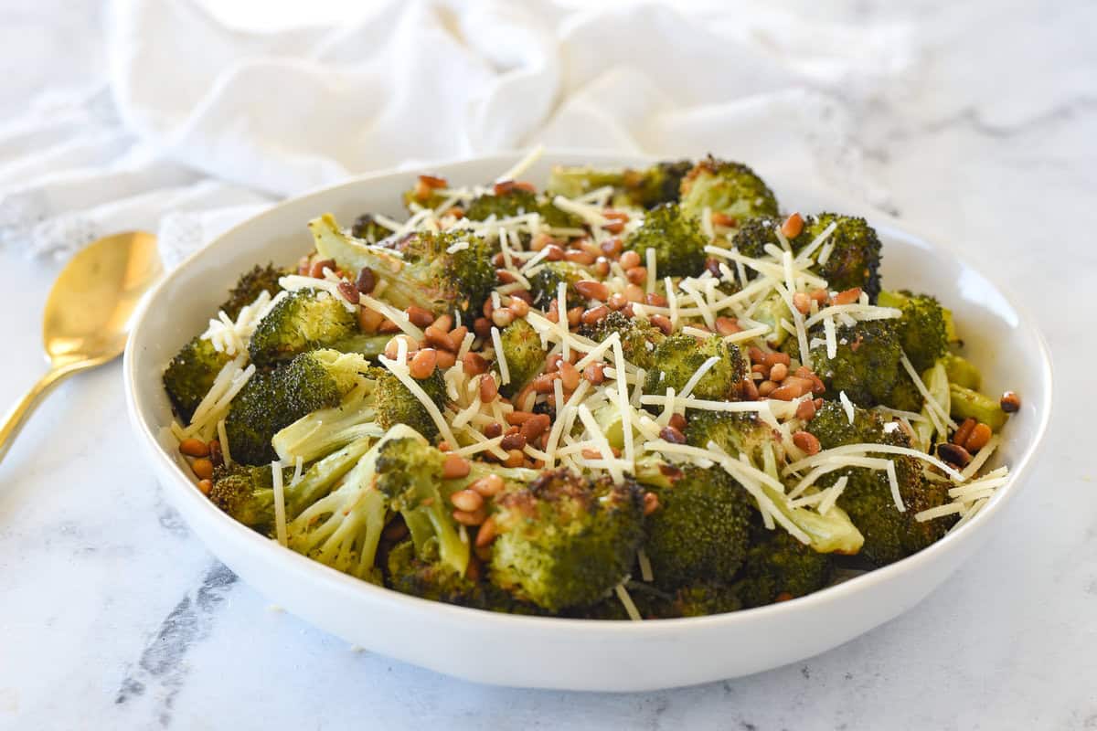 white bowl full of roasted broccoli

