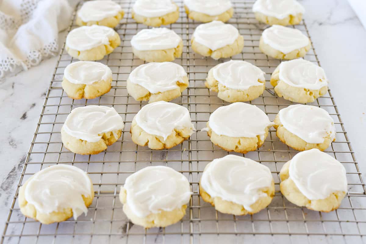 frosted sugar cookies on cooling rack