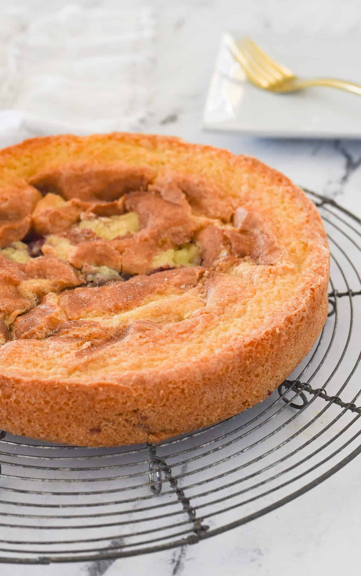 side view of a plum cake on a cooling rack