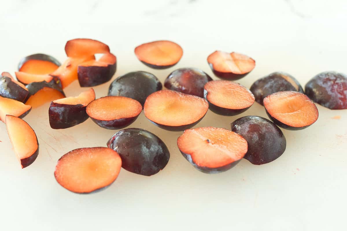 sliced plums on a cutting board
