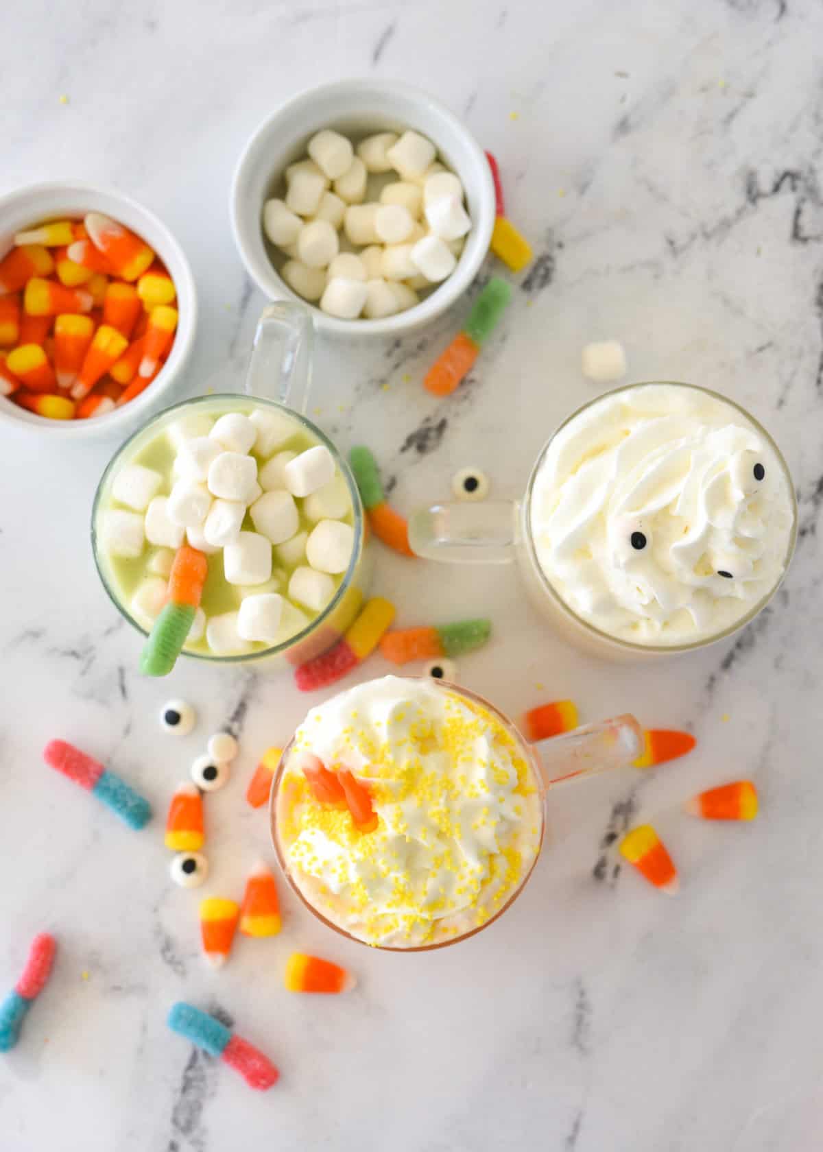 overhead view of three mugs of halloween hot chocolate