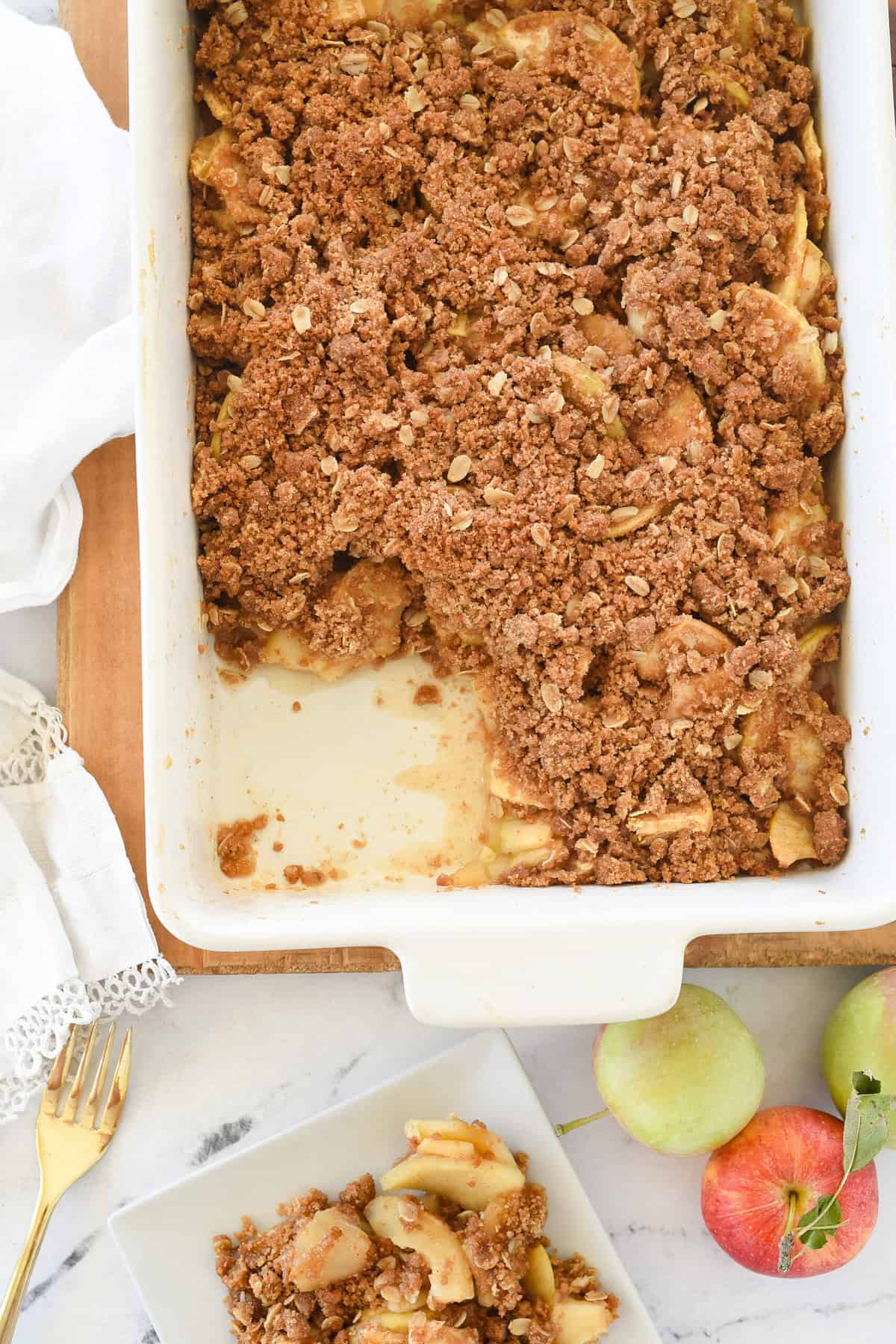 pan of apple crisp with one serving missing