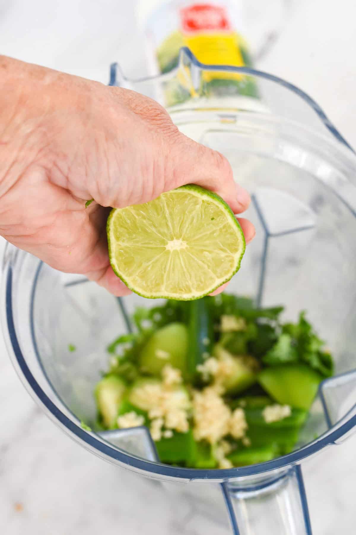 adding lime juice into blender.
