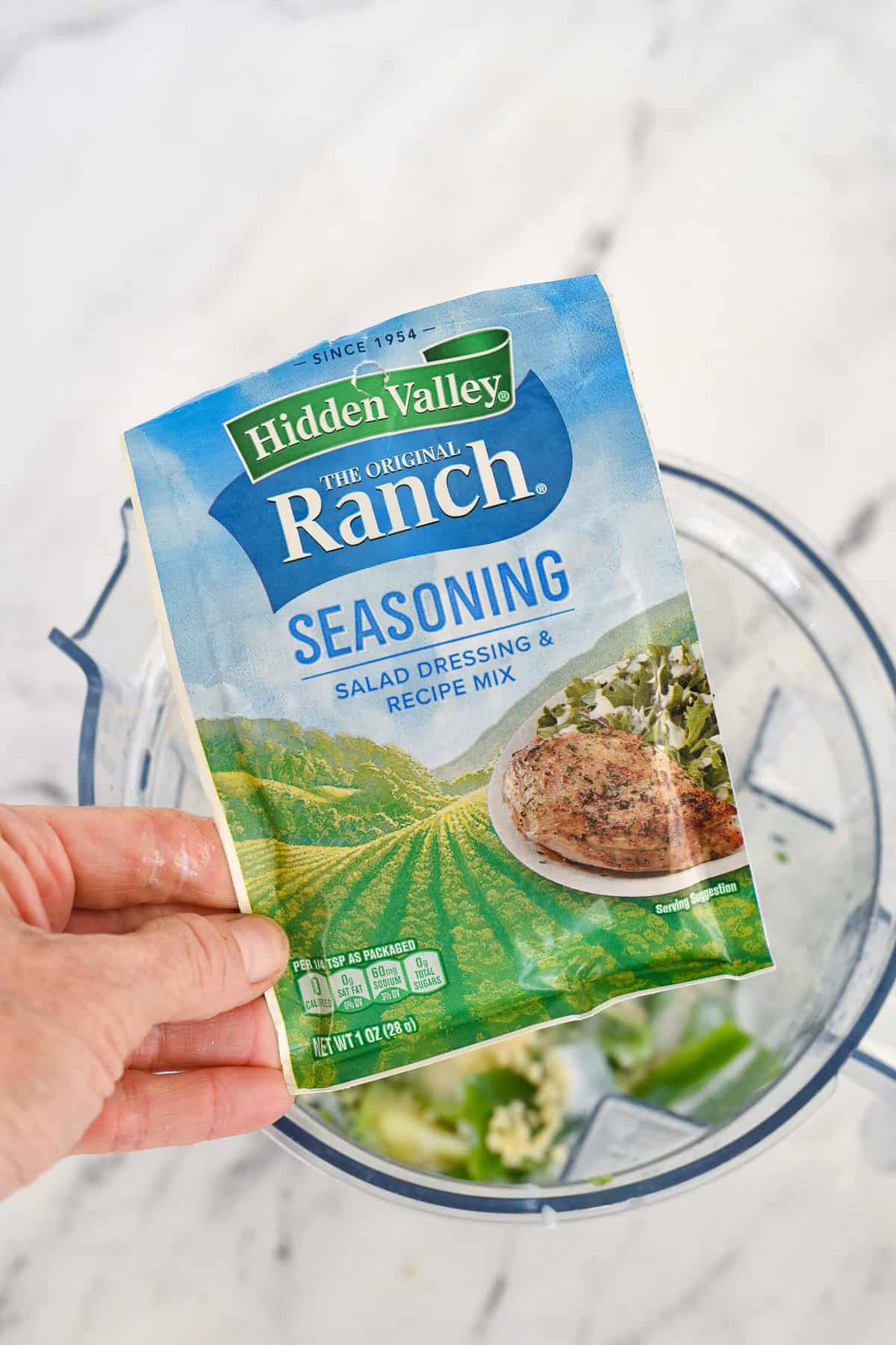 adding ranch seasoning to blender