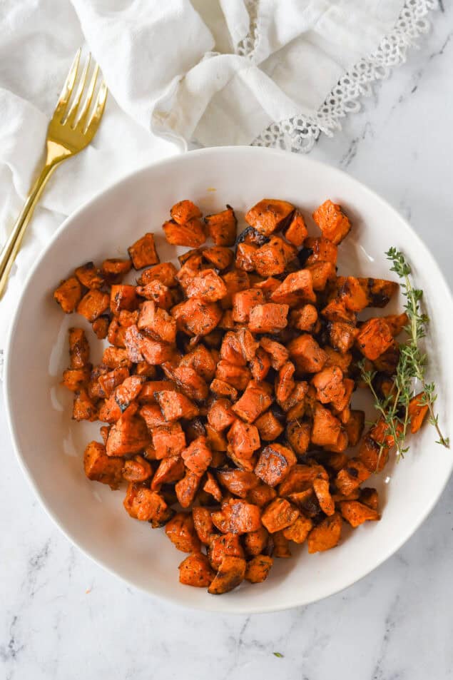 white bowl of roasted sweet potatoes