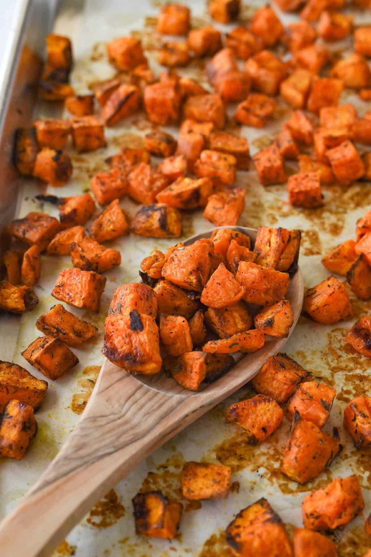 wooden spoon full of roasted sweet potatoes