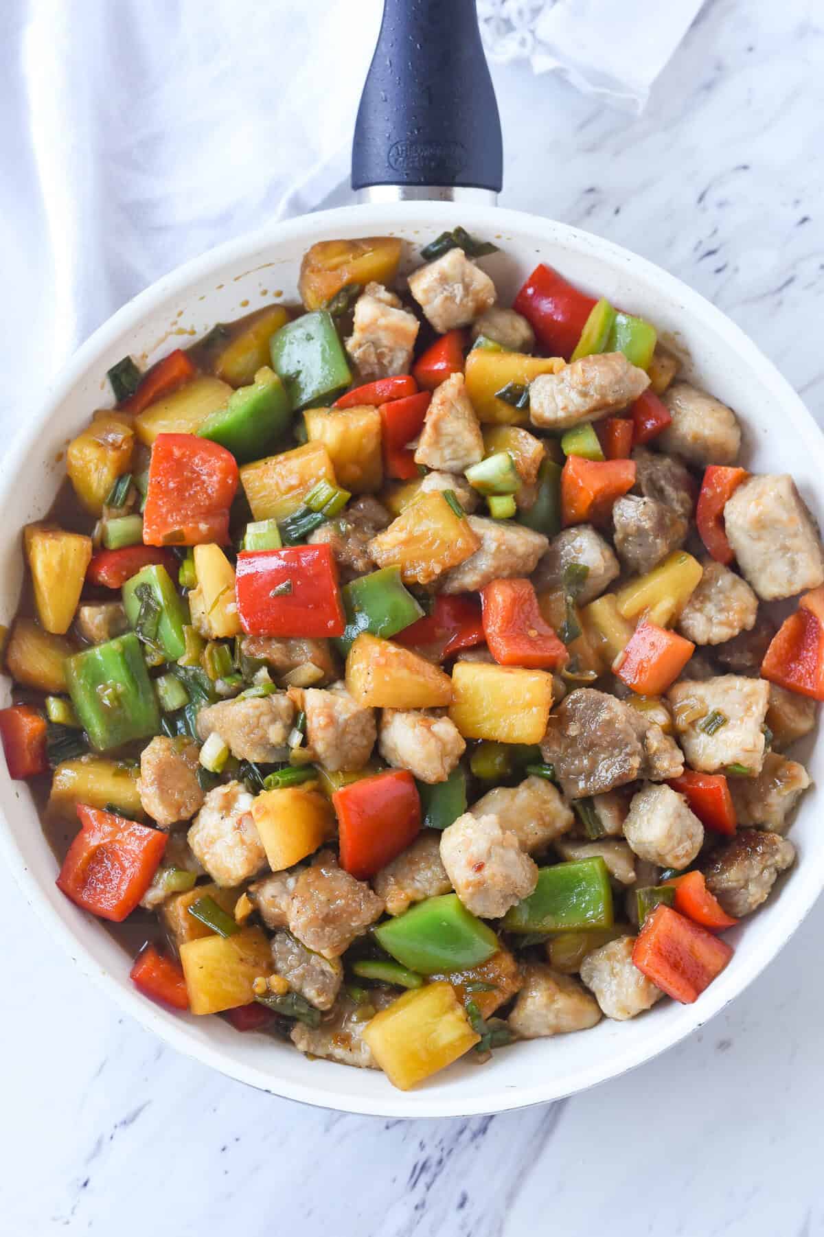 frying pan full of sweet and sour pork