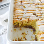 pan of cinnamon roll cake with piece missing
